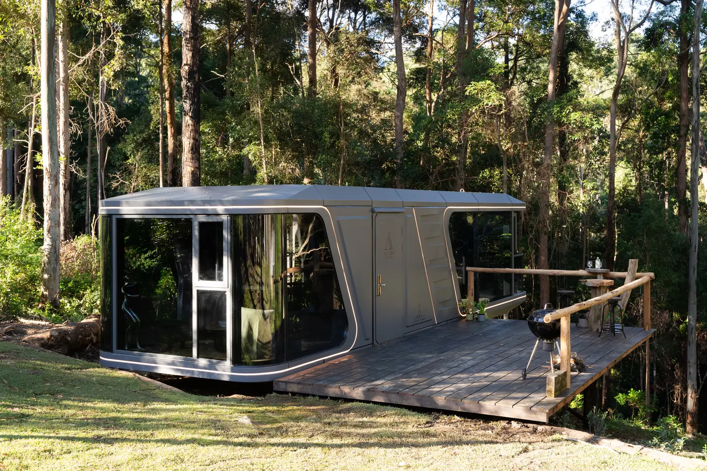The Aluxria Sage (K70) cabin on a timber deck in a bushland clearing